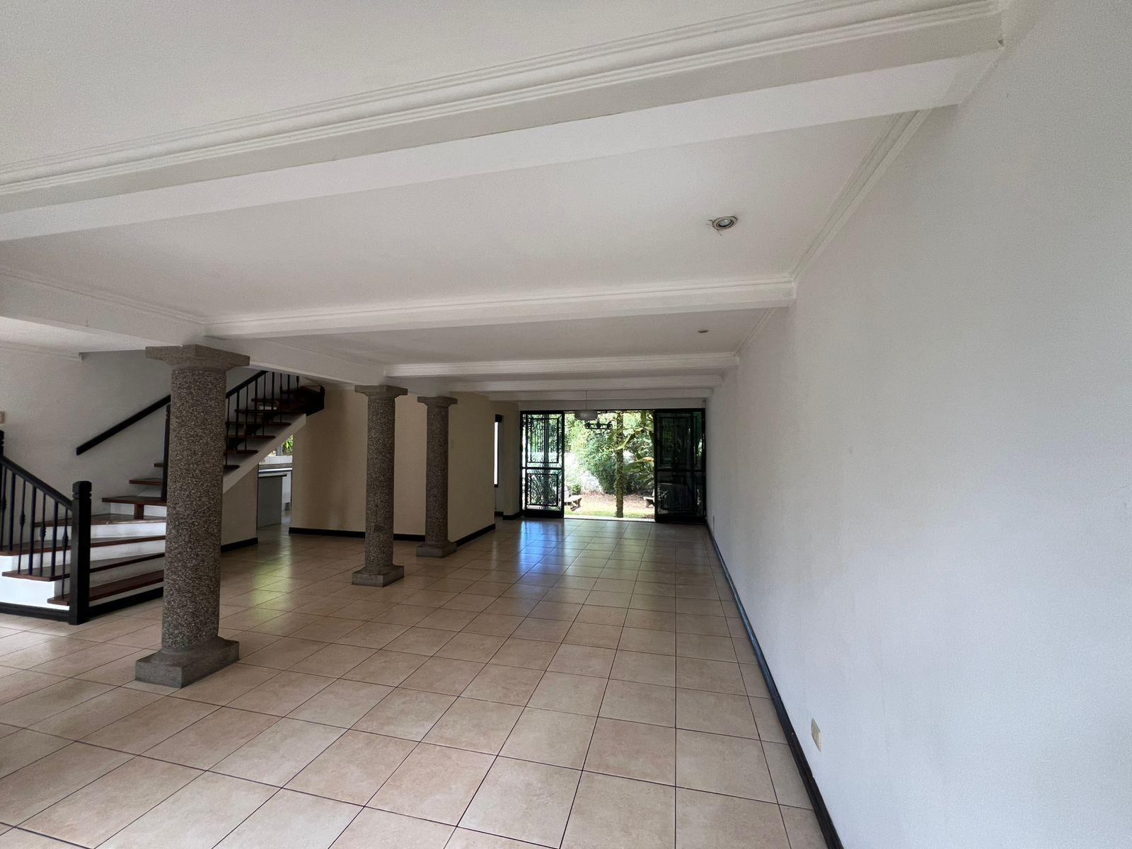 Sala comedor de casa de dos niveles con jardín frontal en venta San Rafael de Escazú